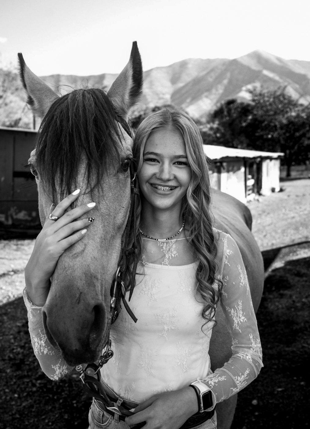 Kennedy smiling with her horse, in black and white